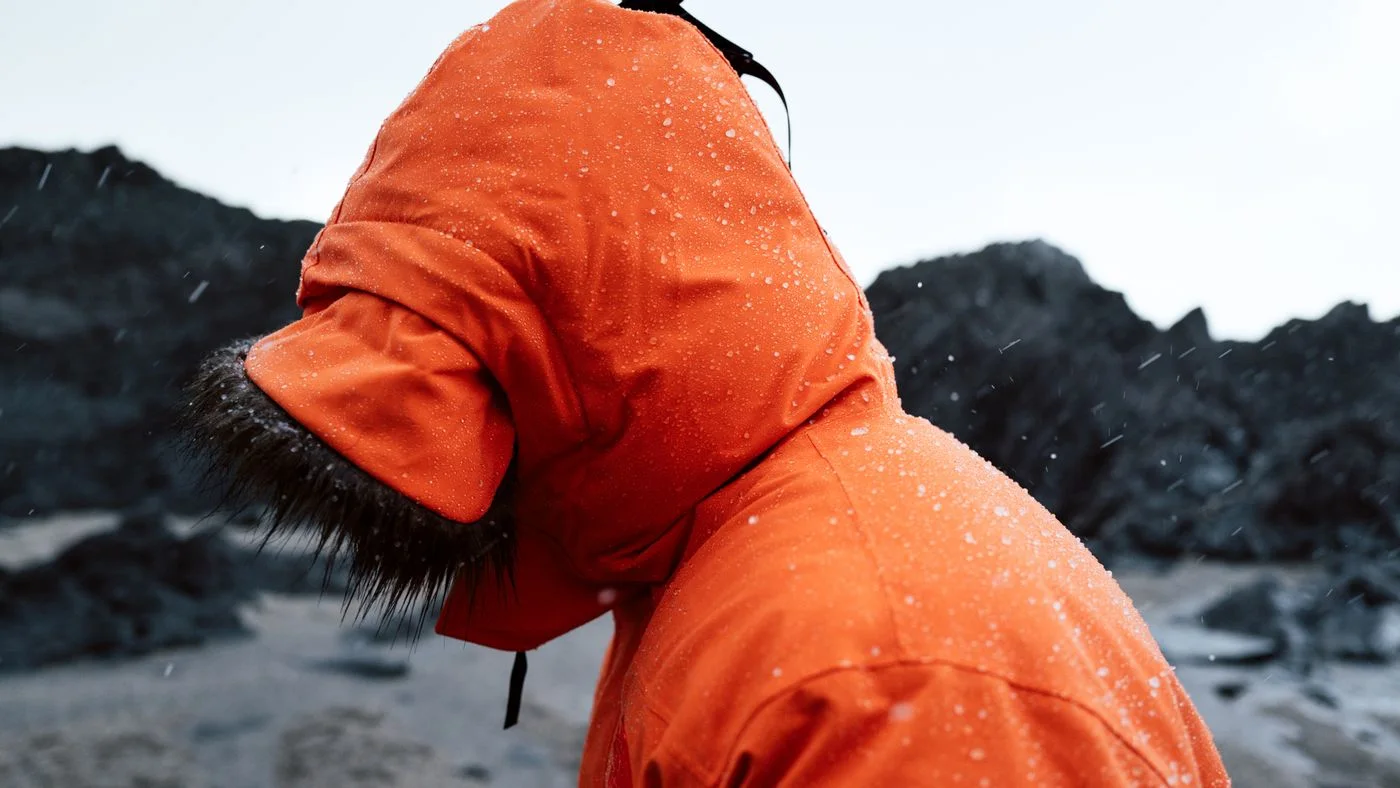 The hood of an orange rain jacket.